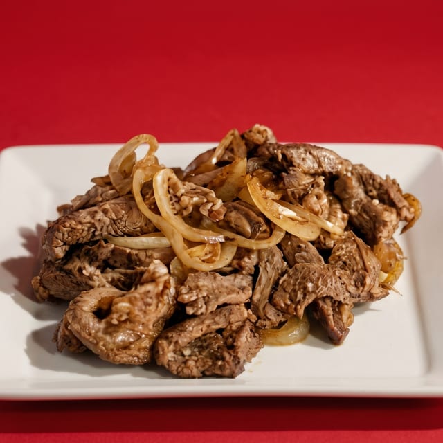 Bisteck Encebollado.